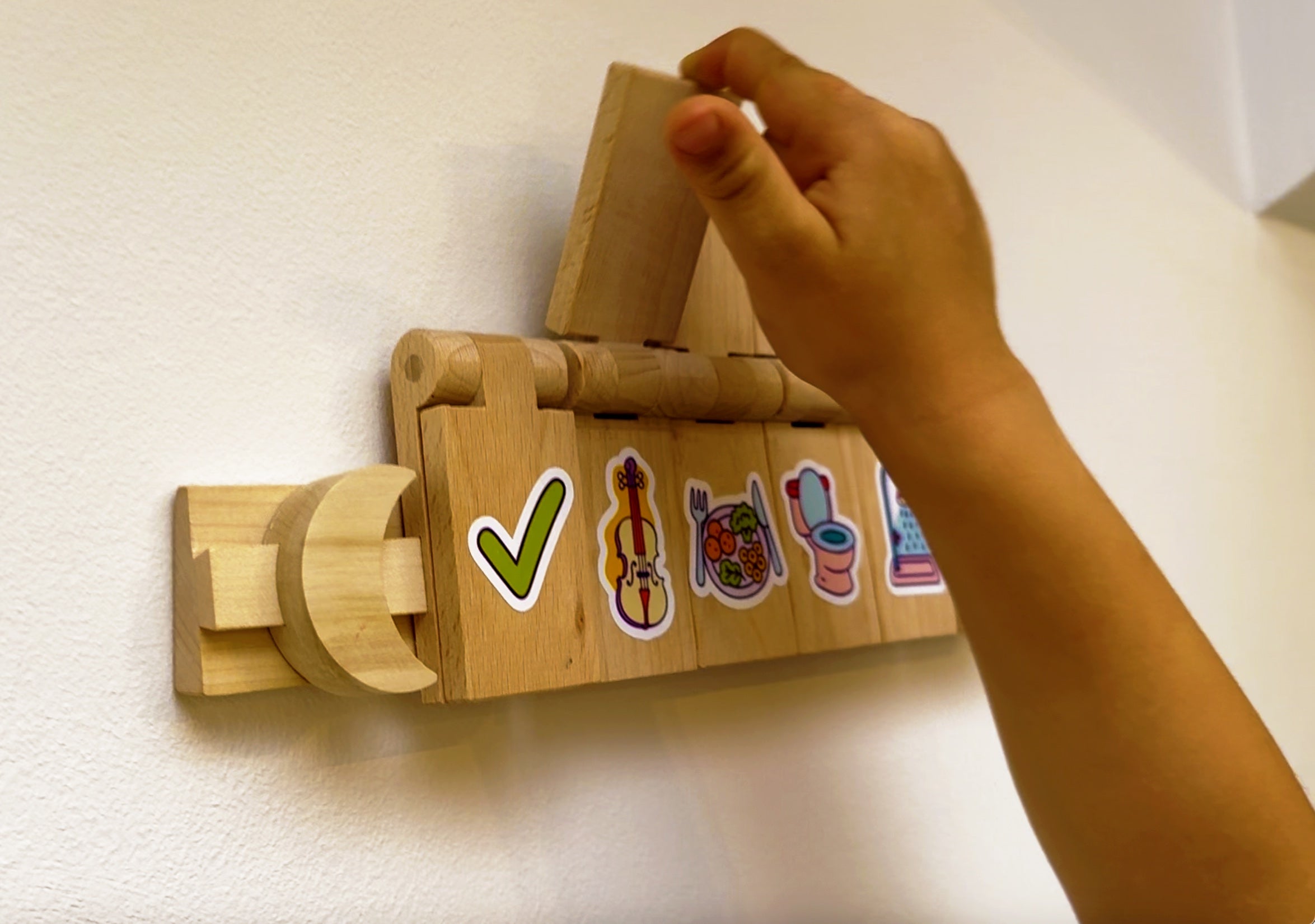 Close-up of a hand closing a Flipzy task tile